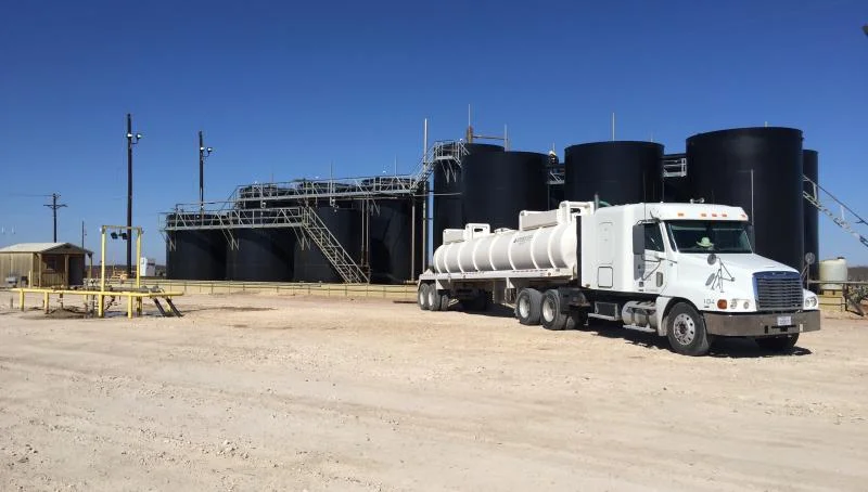 Vacuum truck handling produced water on a lease site